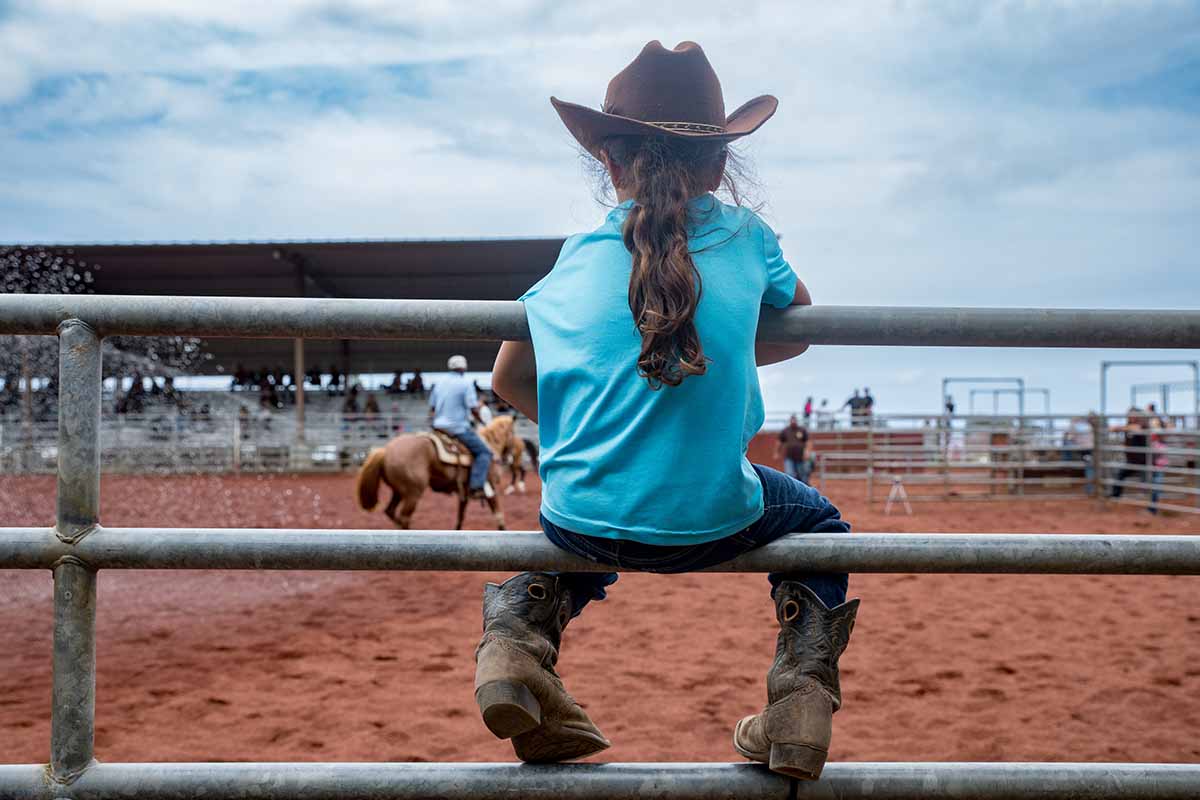 Young girl watching the rodeo